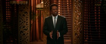 Movie still from “One Night in Miami...” (2020), directed by Regina King – A man wearing a suit and tie standing in front of an audience; Medium shot, Over the shoulder angle