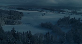 Movie still from “Orphan: First Kill” (2022), directed by William Brent Bell – A view of a snow covered field at night; Extreme Wide shot, High angle