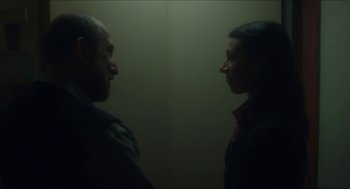 Movie still from “Orphan: First Kill” (2022), directed by William Brent Bell – A man and a woman standing next to each other; Close Up shot, Over the shoulder angle