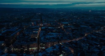 Movie still from “Orphan: First Kill” (2022), directed by William Brent Bell – An aerial view of a city at night with lights; Extreme Wide shot, High angle