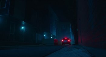 Movie still from “Orphan: First Kill” (2022), directed by William Brent Bell – A red car driving down a street at night; Extreme Wide shot, Low angle