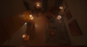 Movie still from “Orphan: First Kill” (2022), directed by William Brent Bell – An overhead view of a living room at night time; Extreme Wide shot, Overhead angle