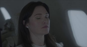 Movie still from “Orphan: First Kill” (2022), directed by William Brent Bell – A woman with her eyes closed listening to music; Close Up shot, High angle