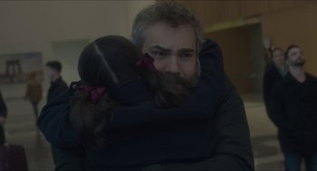 Movie still from “Orphan: First Kill” (2022), directed by William Brent Bell – A man and a little girl hugging each other; Close Up shot, Over the shoulder angle