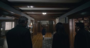 Movie still from “Orphan: First Kill” (2022), directed by William Brent Bell – A group of people walking in a room; Wide shot, Over the shoulder angle