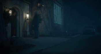 Movie still from “Orphan: First Kill” (2022), directed by William Brent Bell – A man walking down the sidewalk at night; Wide shot, Low angle