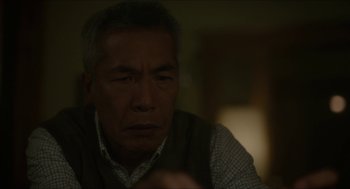 Movie still from “Orphan: First Kill” (2022), directed by William Brent Bell – An older man sitting at a table in front of a window; Close Up shot, Over the shoulder angle