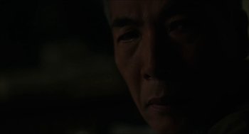 Movie still from “Orphan: First Kill” (2022), directed by William Brent Bell – An older man is looking at the camera; Extreme Close Up shot, Over the shoulder angle