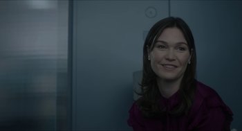 Movie still from “Orphan: First Kill” (2022), directed by William Brent Bell – A woman in a purple shirt smiling for the camera; Close Up shot, Over the shoulder angle