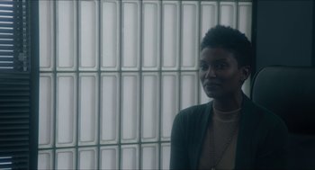 Movie still from “Orphan: First Kill” (2022), directed by William Brent Bell – A woman standing in front of a wall; Medium shot, Low angle