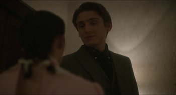 Movie still from “Orphan: First Kill” (2022), directed by William Brent Bell – A man in a suit looking at a woman in the mirror; Close Up shot, Over the shoulder angle