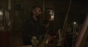 Movie still from “Orphan: First Kill” (2022), directed by William Brent Bell – A man and a woman are painting on easels; Medium shot, Over the shoulder angle
