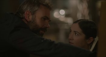Movie still from “Orphan: First Kill” (2022), directed by William Brent Bell – A man and a woman looking at one another; Close Up shot, Over the shoulder angle