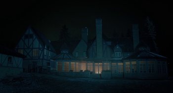 Movie still from “Orphan: First Kill” (2022), directed by William Brent Bell – A large building that is lit up at night; Extreme Wide shot, Low angle