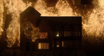 Movie still from “Orphan: First Kill” (2022), directed by William Brent Bell – A building on fire in a dark night; Extreme Wide shot, Low angle