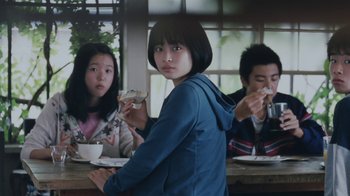 Movie still from “Our Little Sister” (2015), directed by Kore-eda Hirokazu – Three people sitting at a table eating donuts; Medium shot, Low angle