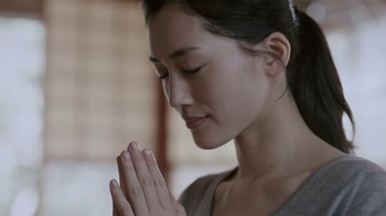 Movie still from “Our Little Sister” (2015), directed by Kore-eda Hirokazu – A young woman is praying with her hands folded together; Close Up shot, Low angle