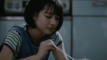 Movie still from “Our Little Sister” (2015), directed by Kore-eda Hirokazu – A young woman is holding a toothbrush in her hand; Close Up shot, Over the shoulder angle