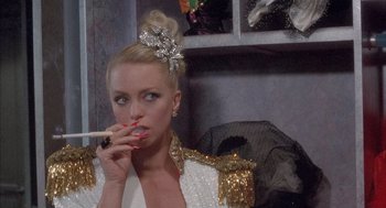 Movie still from “Overboard” (1987), directed by Garry Marshall – A woman smoking a cigarette while wearing a dress; Close Up shot, Low angle