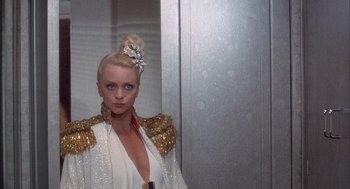Movie still from “Overboard” (1987), directed by Garry Marshall – A woman with blonde hair wearing a white dress; Medium shot, Low angle