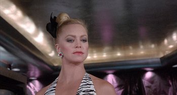 Movie still from “Overboard” (1987), directed by Garry Marshall – A woman in a white and black dress with a black bow in her hair; Close Up shot, Low angle