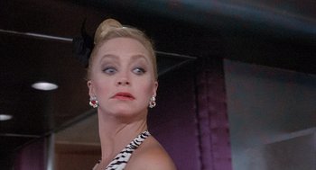 Movie still from “Overboard” (1987), directed by Garry Marshall – A person wearing a dress; Close Up shot, Low angle