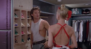 Movie still from “Overboard” (1987), directed by Garry Marshall – A man and a woman are talking in front of a mirror; Medium shot, Over the shoulder angle