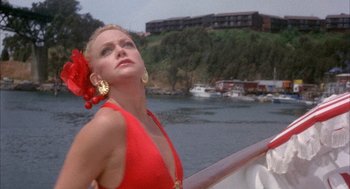 Movie still from “Overboard” (1987), directed by Garry Marshall – A woman in a red dress on a boat in the water; Close Up shot, Low angle
