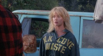 Movie still from “Overboard” (1987), directed by Garry Marshall – A woman standing in front of an old blue truck; Close Up shot, Low angle