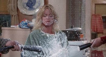 Movie still from “Overboard” (1987), directed by Garry Marshall – A woman is washing dishes in the kitchen; Medium shot, Low angle