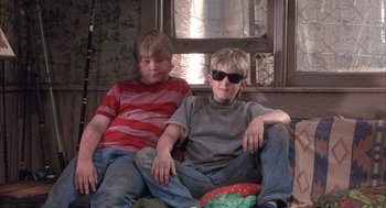Movie still from “Overboard” (1987), directed by Garry Marshall – Two young boys sitting next to each other on a couch; Medium shot, Low angle