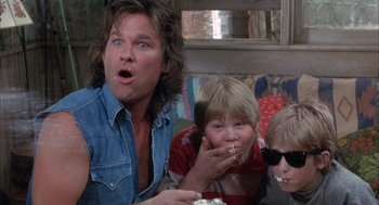 Movie still from “Overboard” (1987), directed by Garry Marshall – A man and two boys are eating popcorn; Close Up shot, Low angle