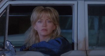 Movie still from “Overboard” (1987), directed by Garry Marshall – A woman looking out of a car window at night; Close Up shot, Over the shoulder angle