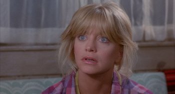 Movie still from “Overboard” (1987), directed by Garry Marshall – A person wearing a plaid shirt; Close Up shot, Over the shoulder angle