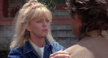 Movie still from “Overboard” (1987), directed by Garry Marshall – A woman talking to a man in front of a building; Close Up shot, Over the shoulder angle