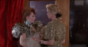 Movie still from “Overboard” (1987), directed by Garry Marshall – Two women are standing in front of a mirror; Medium shot, Over the shoulder angle