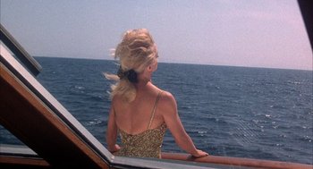 Movie still from “Overboard” (1987), directed by Garry Marshall – A woman standing on a boat looking out at the ocean; Medium shot, High angle