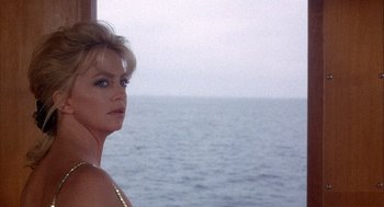 Movie still from “Overboard” (1987), directed by Garry Marshall – A woman standing in front of a body of water; Close Up shot, Low angle