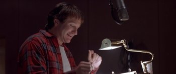 Movie still from “Mrs. Doubtfire” (1993), directed by Chris Columbus – A man in a recording studio with a microphone; Close Up shot, Low angle
