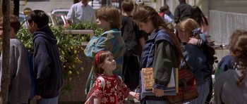 Movie still from “Mrs. Doubtfire” (1993), directed by Chris Columbus – Two young girls holding hands while standing next to each other; Medium shot, Over the shoulder angle
