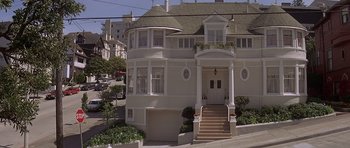 Movie still from “Mrs. Doubtfire” (1993), directed by Chris Columbus – A large white house with steps leading up to it's front door; Wide shot, Low angle