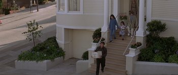 Movie still from “Mrs. Doubtfire” (1993), directed by Chris Columbus – A man and two children walking down the steps of a house; Wide shot, High angle