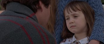 Movie still from “Mrs. Doubtfire” (1993), directed by Chris Columbus – A little girl sitting next to a man on a train; Close Up shot, Over the shoulder angle