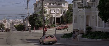 Movie still from “Mrs. Doubtfire” (1993), directed by Chris Columbus – A stop sign is posted on the corner of a street; Wide shot, High angle