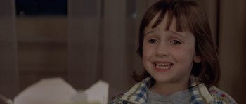 Movie still from “Mrs. Doubtfire” (1993), directed by Chris Columbus – A little girl smiling for the camera; Close Up shot, Over the shoulder angle