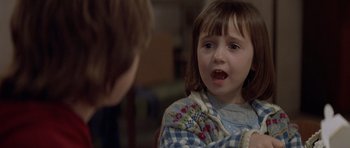 Movie still from “Mrs. Doubtfire” (1993), directed by Chris Columbus – A little girl looking at another girl with a surprised look on her face; Close Up shot, Over the shoulder angle