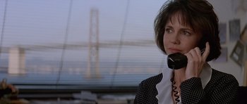 Movie still from “Mrs. Doubtfire” (1993), directed by Chris Columbus – A woman is talking on a phone in front of a bridge; Close Up shot, Over the shoulder angle