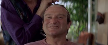 Movie still from “Mrs. Doubtfire” (1993), directed by Chris Columbus – A person with a bald head; Close Up shot, Over the shoulder angle