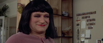 Movie still from “Mrs. Doubtfire” (1993), directed by Chris Columbus – A woman's face with black hair; Close Up shot, High angle