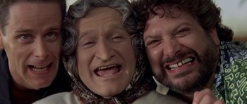 Movie still from “Mrs. Doubtfire” (1993), directed by Chris Columbus – A man and a woman are posing for a picture; Close Up shot, Low angle